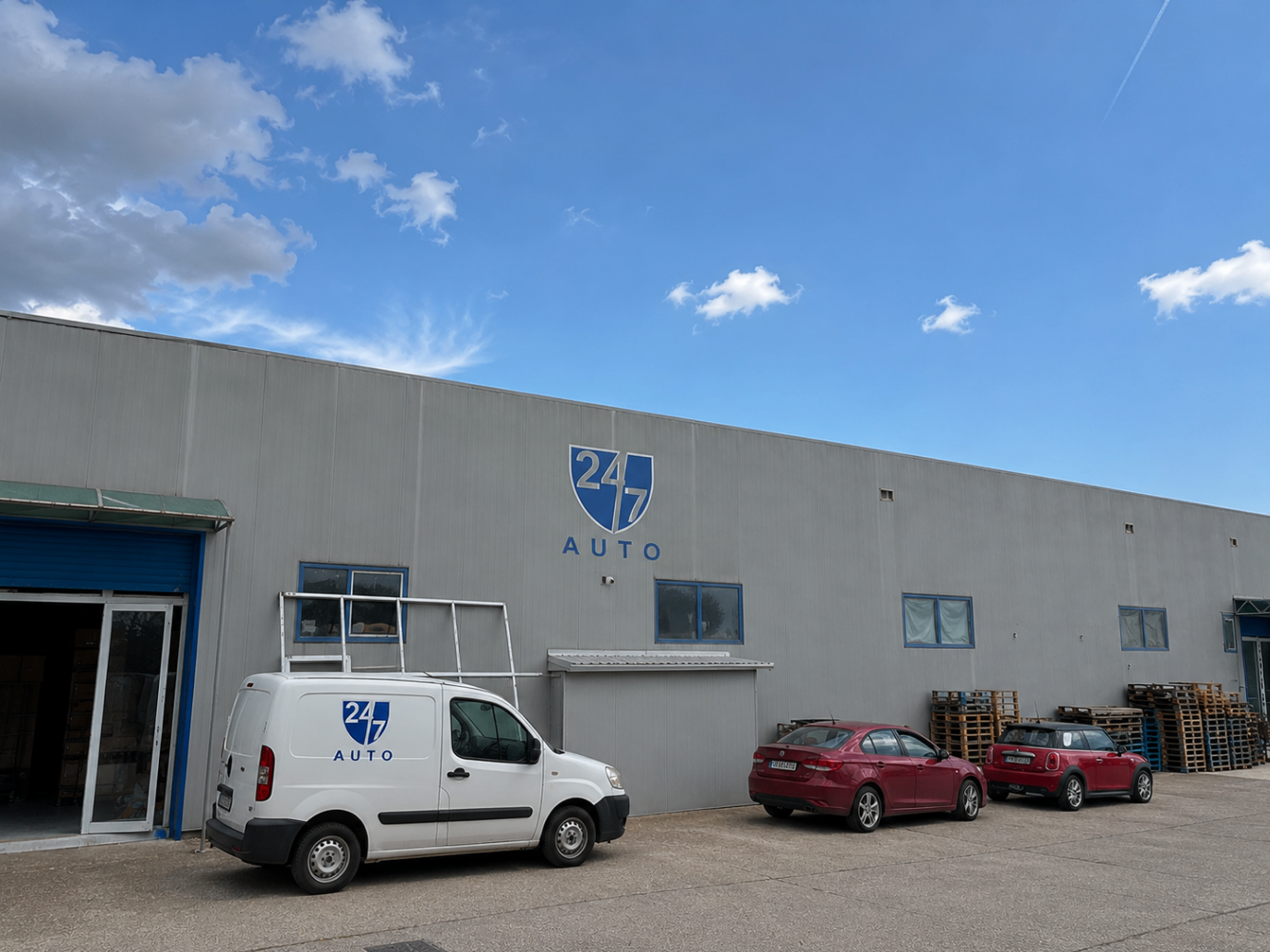 24/7 AUTO warehouse exterior with branded van